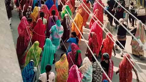 many women in coloured saris